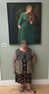 Betty Hauck with portrait by Peder Johnson